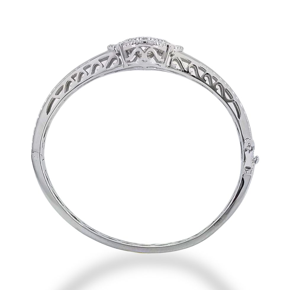 Dancing Diamond center stone surrounded by cushion shaped filigree design with inner and outer border of single row of round CZs